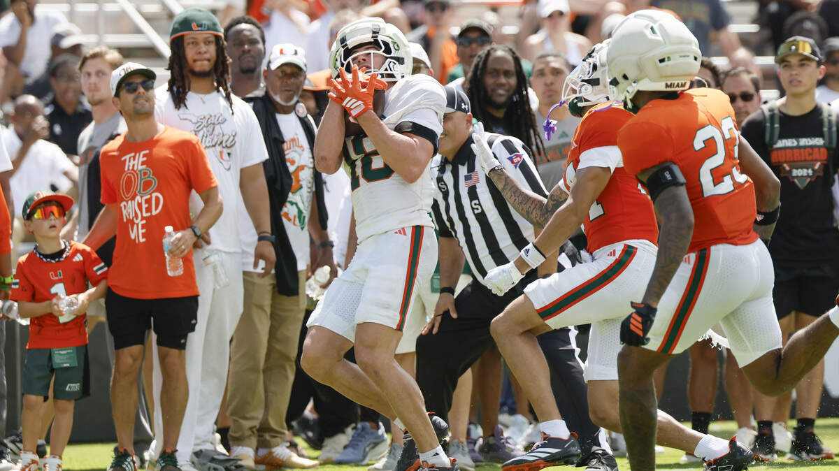 Miami Hurricanes wide receiver Cooper Barkate (18) catches a touchdown pass during UM’s spring football game at Cobb Stadium on the University of Miami campus in Coral Gables, Florida, on Saturday, April 18, 2026.